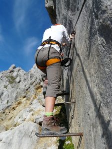 person climbing rock face